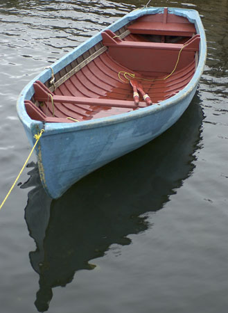 {blue wooden boat rain